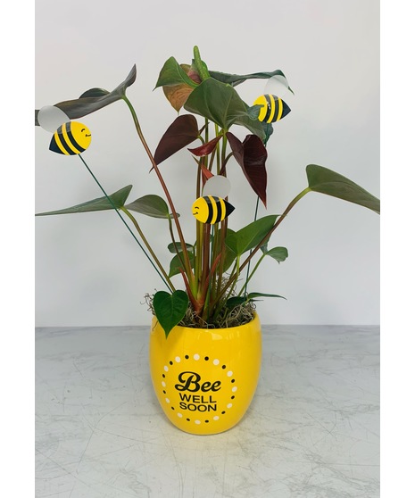 Orange roses, lavender asters and mini sunflowers in a 
