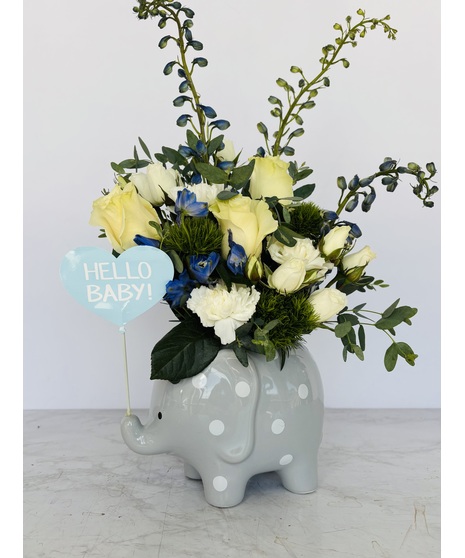 Ceramic elephant with white and blue flowers for a baby boy.