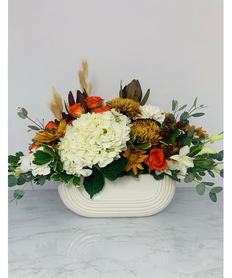 fall toned centerpiece in ceramic container