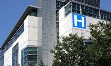 A modern multi-story building with a large blue 
